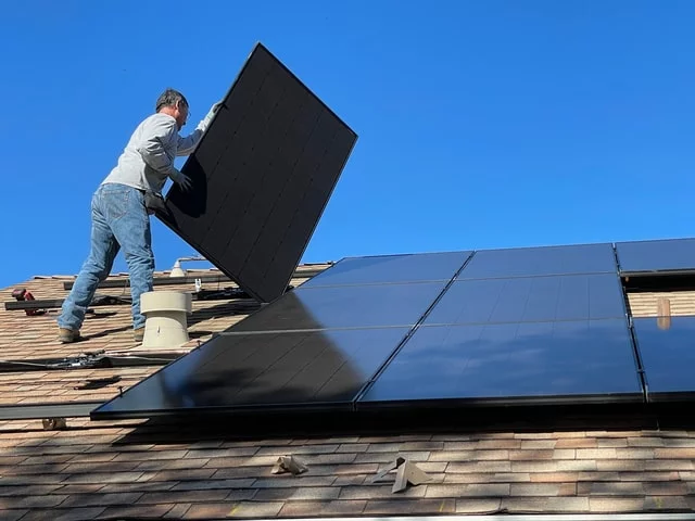 A roof with solar panels being removed