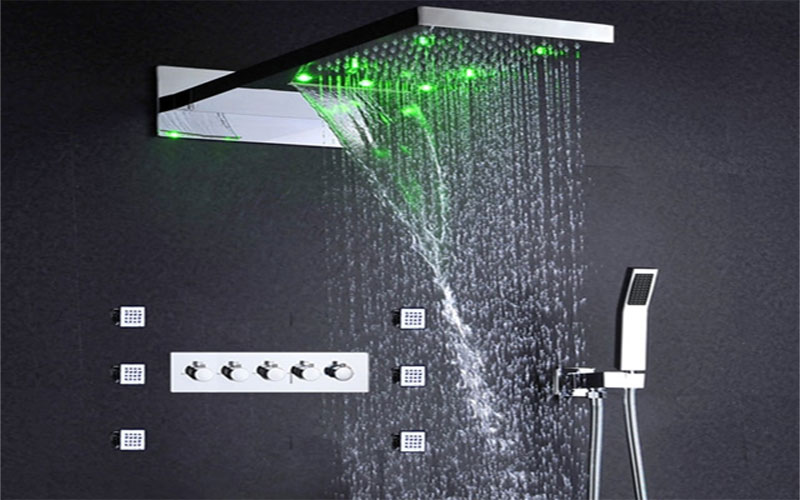 A green LED-lit rainfall shower system.