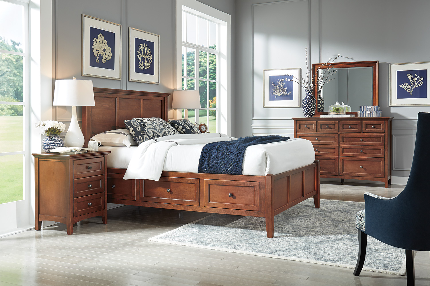 A bedroom with a cherry wood bed and dresser.