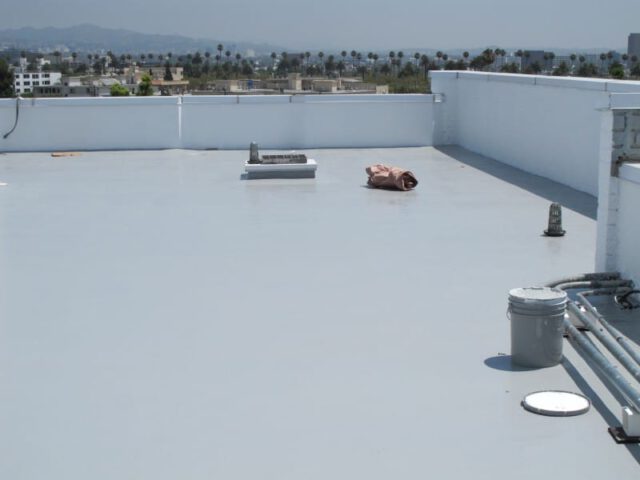 A white roof coated with a flat roof coating.