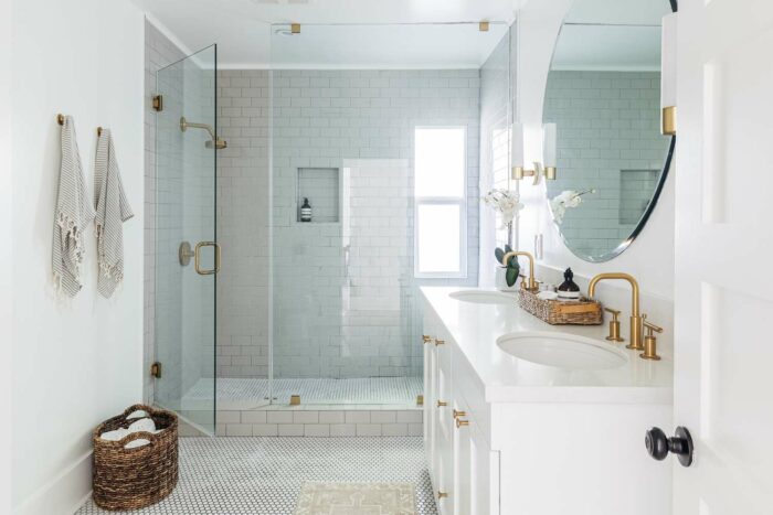 A low maintenance bathroom with a glass shower stall.