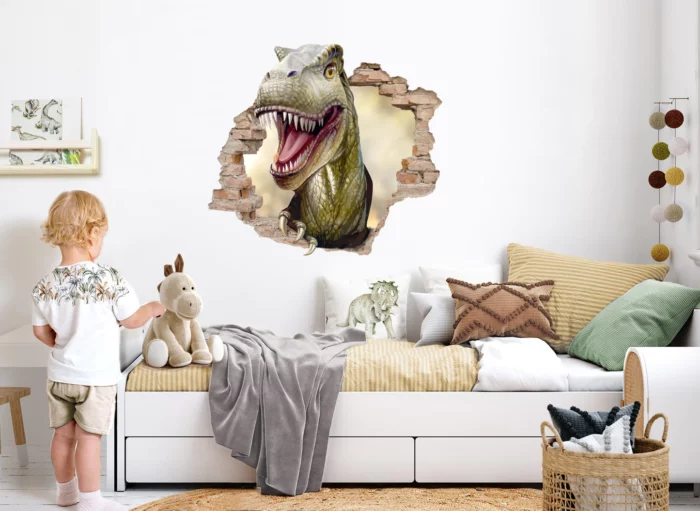 A child's bedroom with a dinosaur wall sticker.