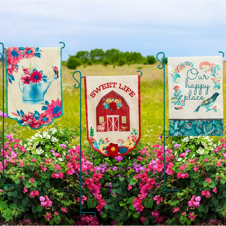 Garden flags displayed in a vibrant flower garden.