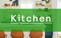 A kitchen with chairs and a green sign that says kitchen.