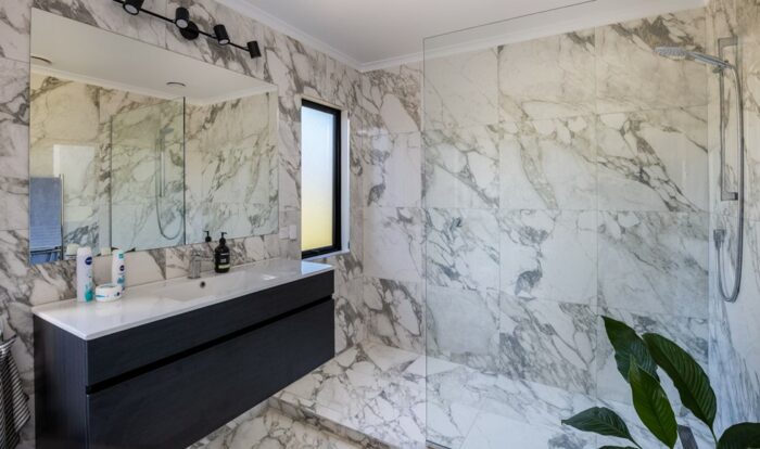 A modern bathroom with low maintenance shower walls.