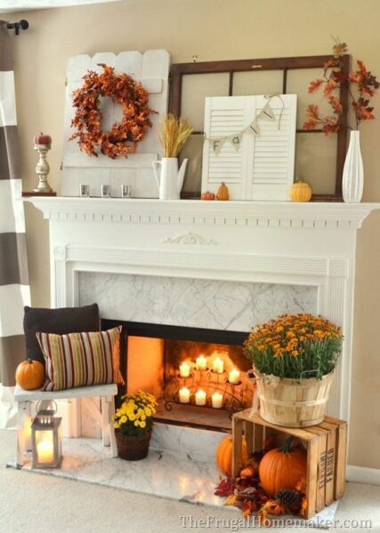 A mantel decorated with wall sconces and candles to create a warm atmosphere