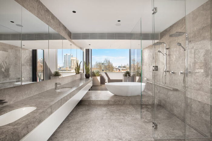 A modern bathroom with glass shower walls.