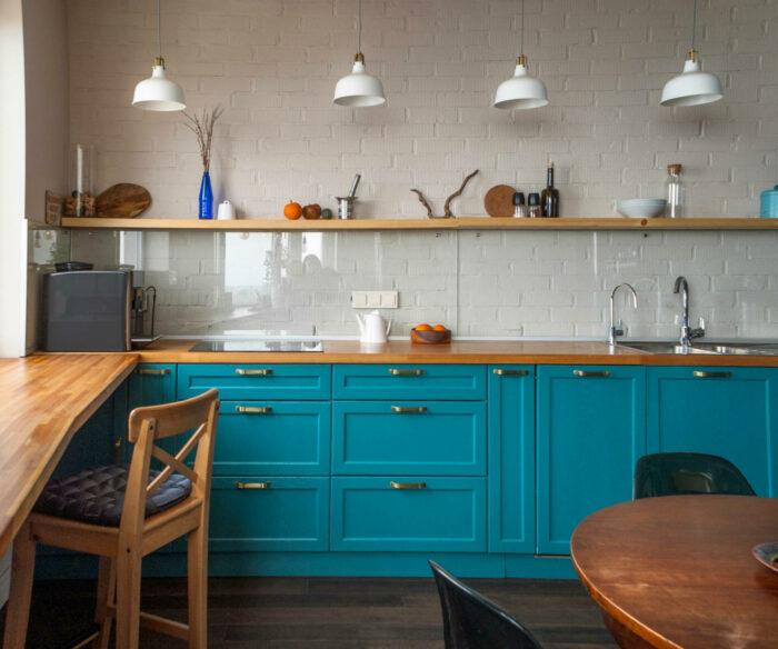 A kitchen with turquoise cabinets.