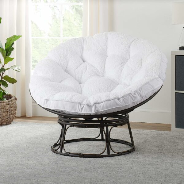A white rattan swivel chair in a living room, perfect for accent seating.