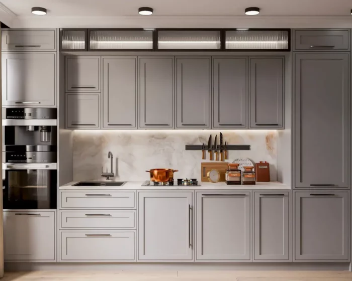 A light gray kitchen with cabinets and a stove.
