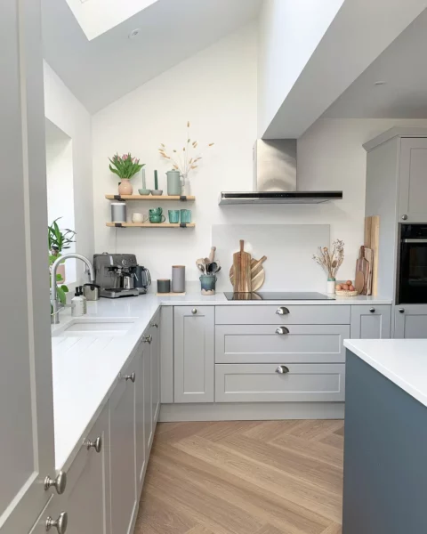 A light gray kitchen with a skylight.