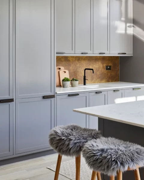 A modern kitchen with light gray cabinets.
