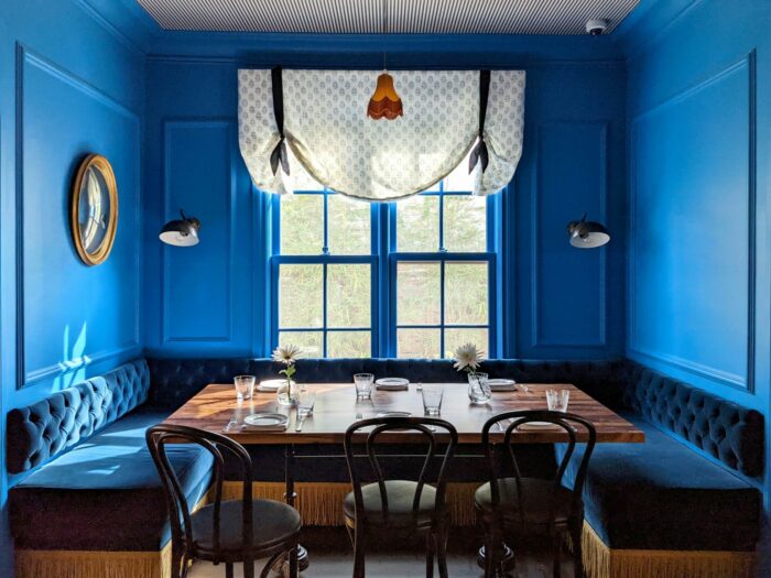 Design ideas for a restaurant dining room with blue walls and a table.