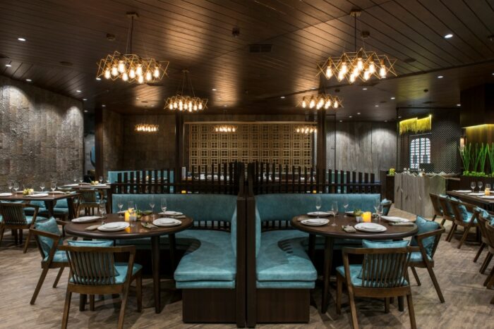 Design ideas for a restaurant with blue booths and wooden tables.