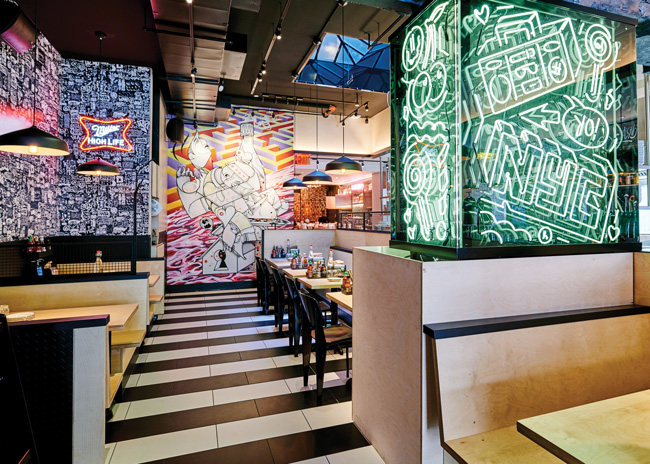 A restaurant with graffiti on the walls, providing design ideas.