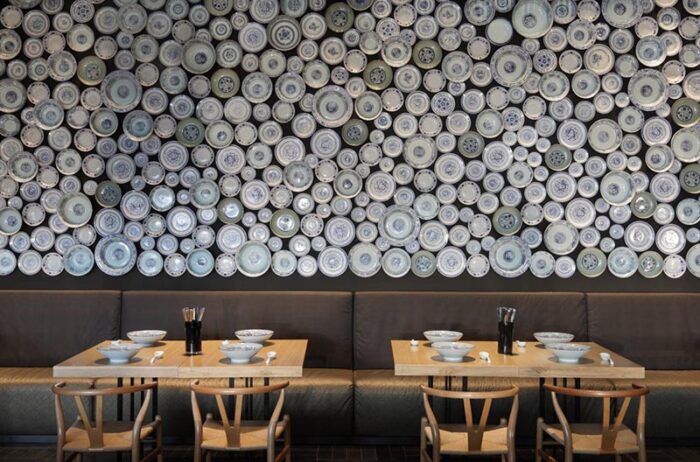 A restaurant with unique design ideas featuring a wall covered in plates.
