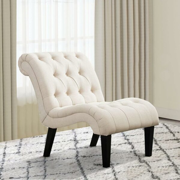 A tufted accent chair in front of a window.
