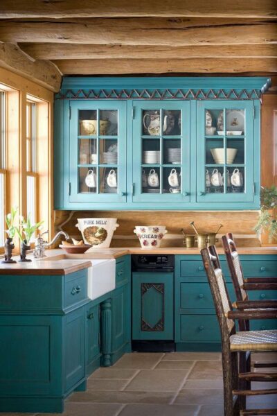 A turquoise kitchen with wooden cabinets