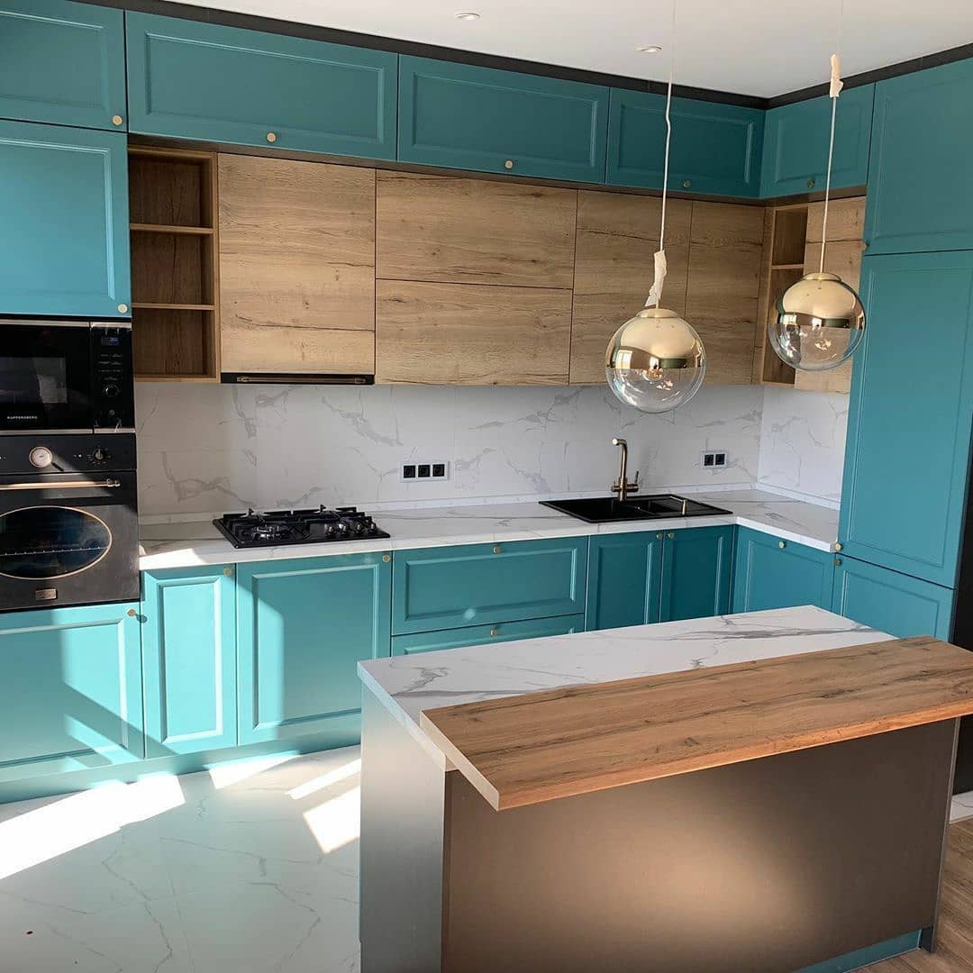 A kitchen with turquoise cabinets and wooden countertops.