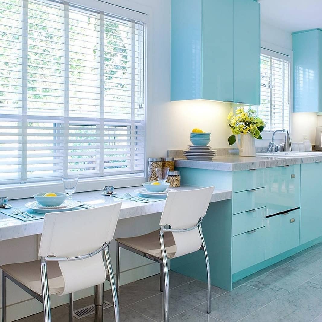 A kitchen with turquoise cabinets.