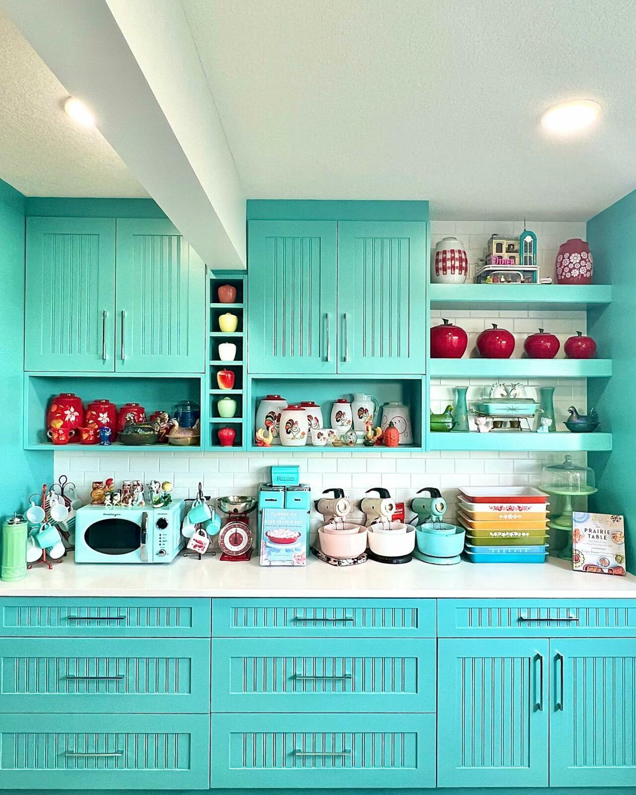 A kitchen with vibrant turquoise cabinets.