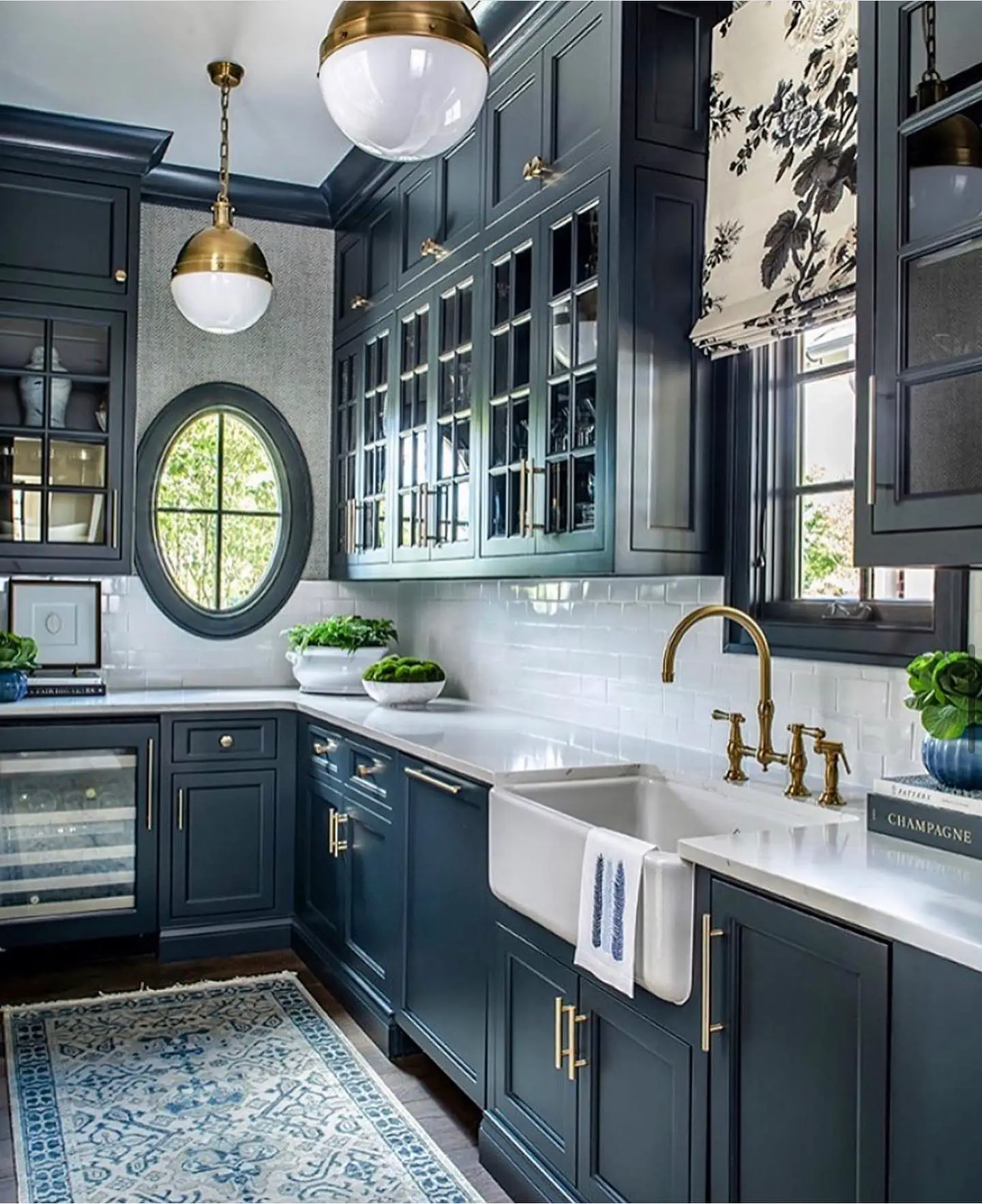 A kitchen with blue cabinets and a blue rug.
