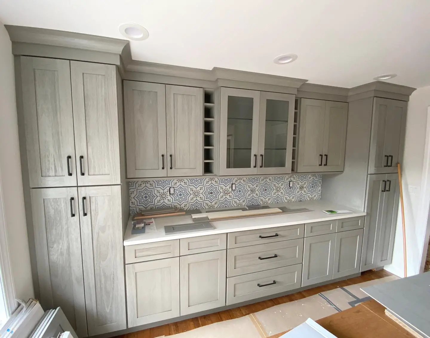 A kitchen with gray cabinets and counter tops.