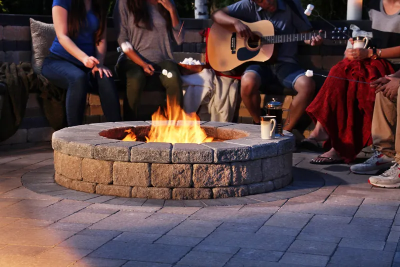 A group of people enjoying the Benefits of Outdoor Fire Pits.