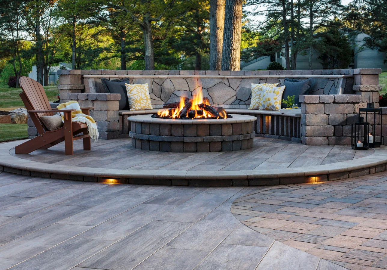 A patio with a fire pit in the middle, showcasing the benefits of outdoor fire pits.