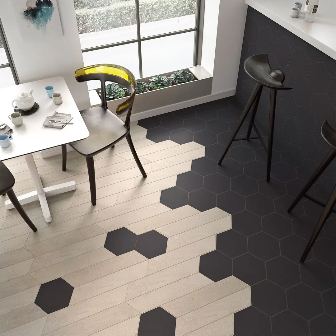 A black and white kitchen with hexagon tiles.