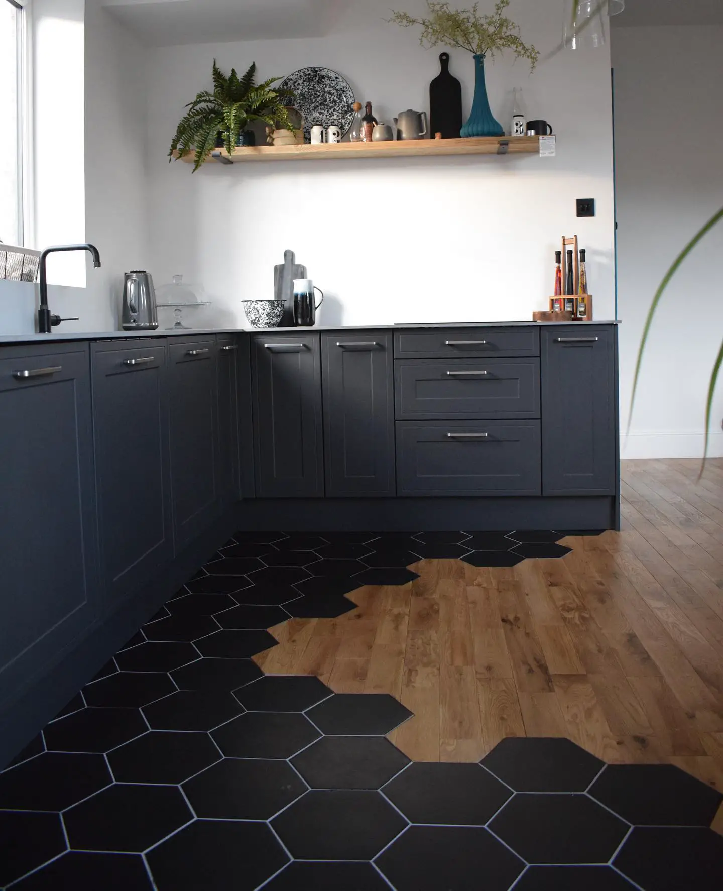 A kitchen with a black floor.
