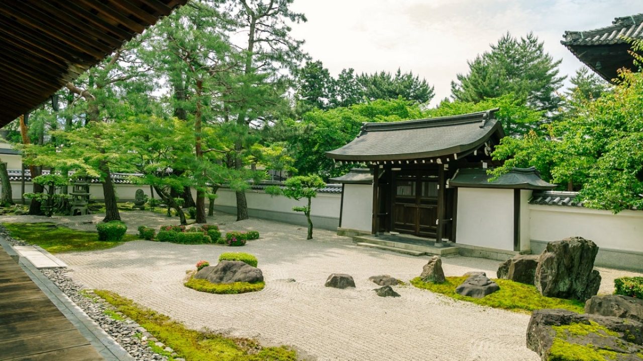 A peaceful and serene Japanese garden adorned with rocks and moss.