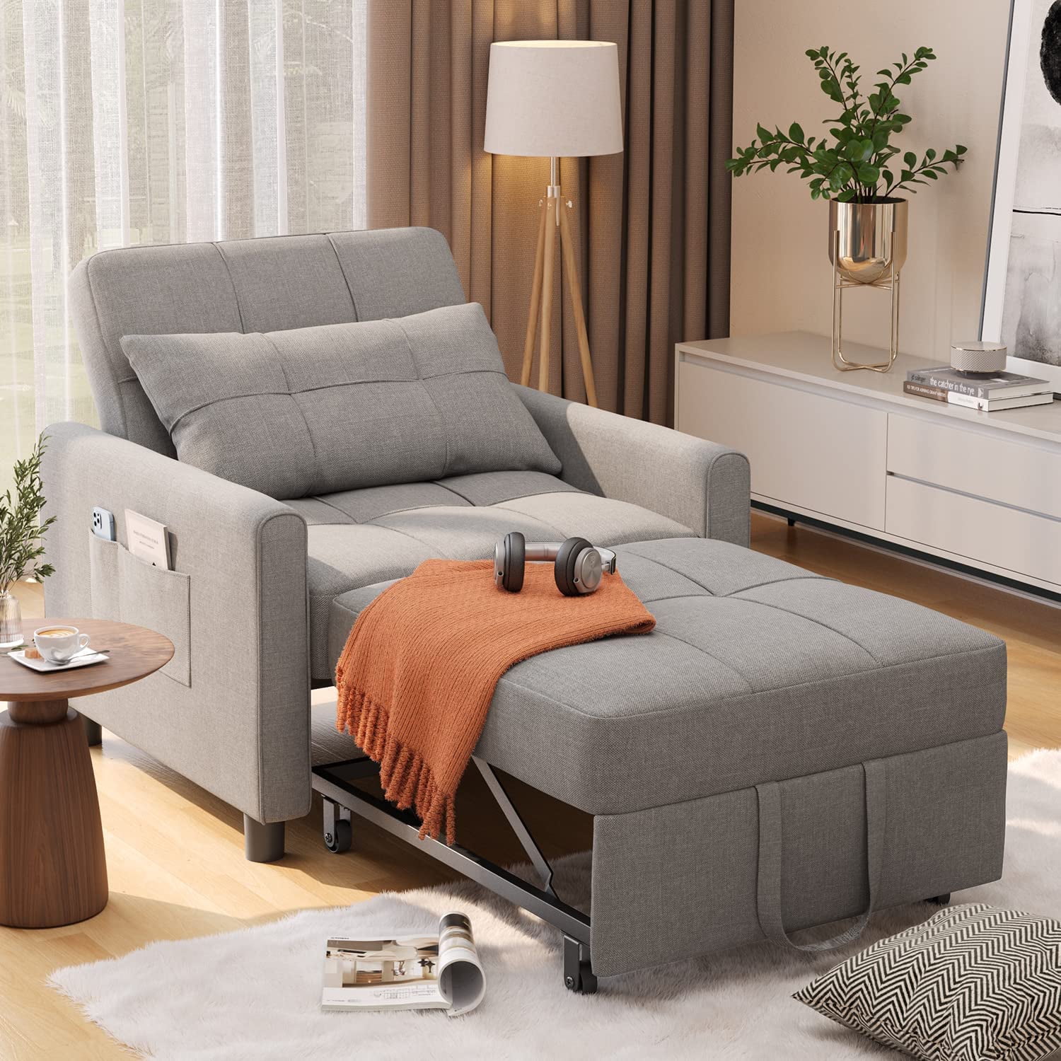 A gray recliner chair with a footrest, perfect for a cozy living room.