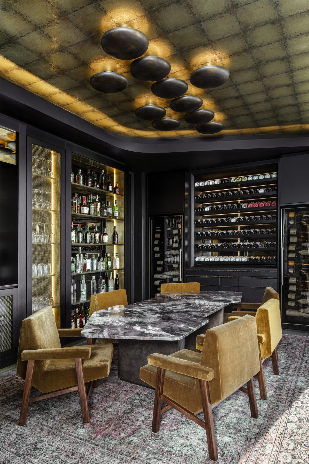 Glen Villa, a wine cellar with a contemporary design featuring a table and chairs.