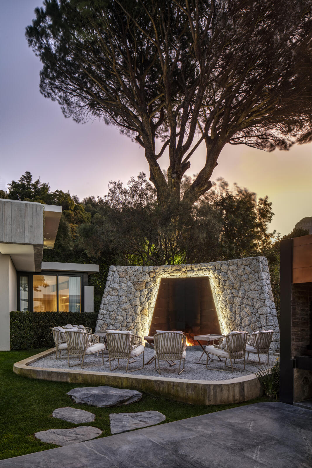 A Glen Villa with a Contemporary Design featuring Nature's Splendor in a modern home with a fire pit in the backyard.