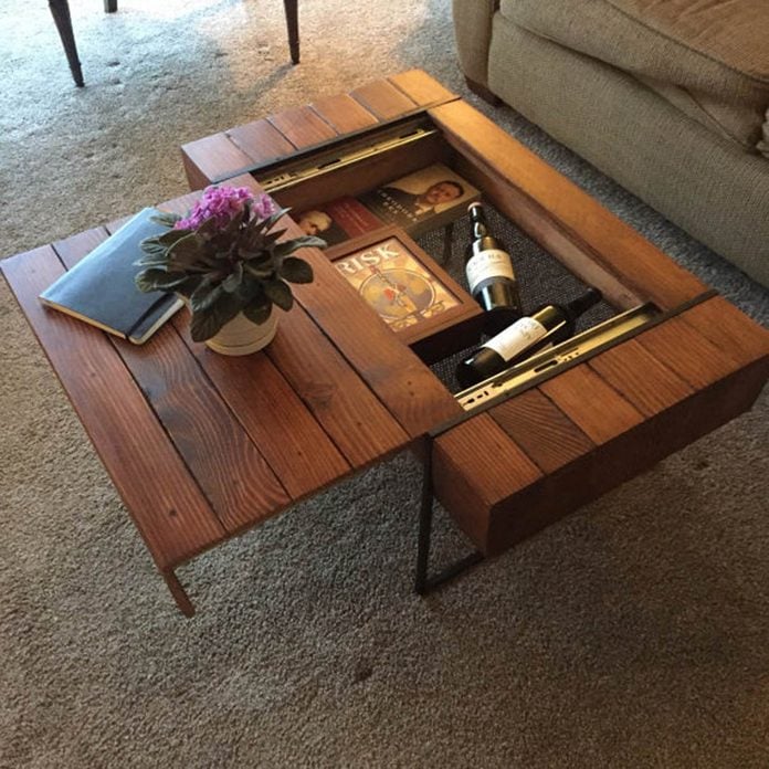Wooden coffee table with hidden compartments and items inside.