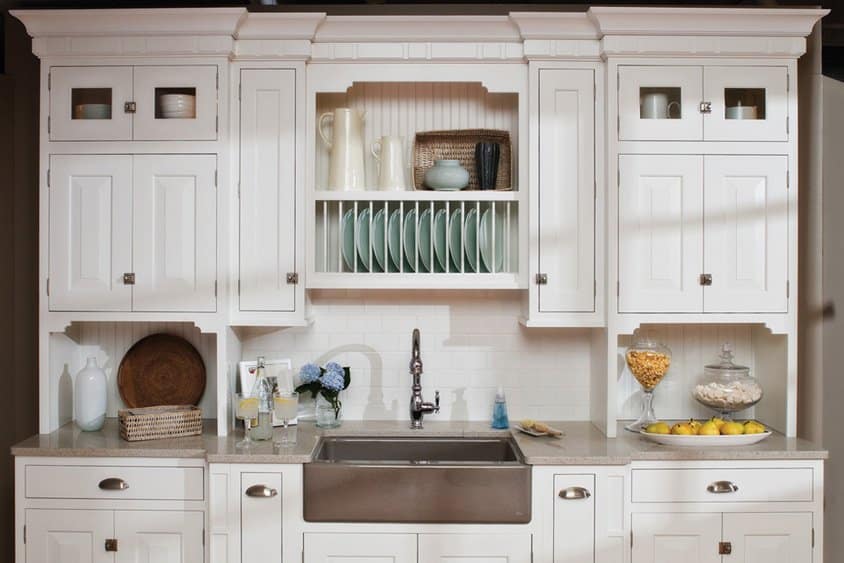 White kitchen cabinets with open shelves and dishware.