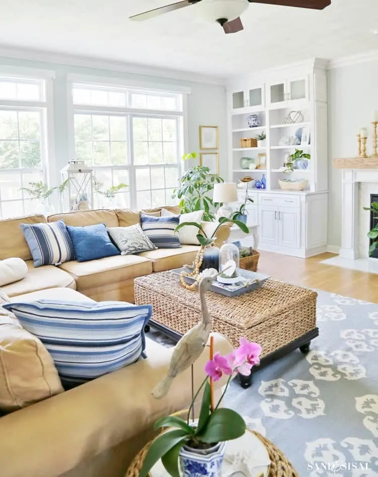 Bright, coastal-style living room with plush seating and plants.
