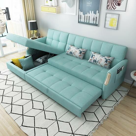 Modern teal sofa bed with storage in a living room.