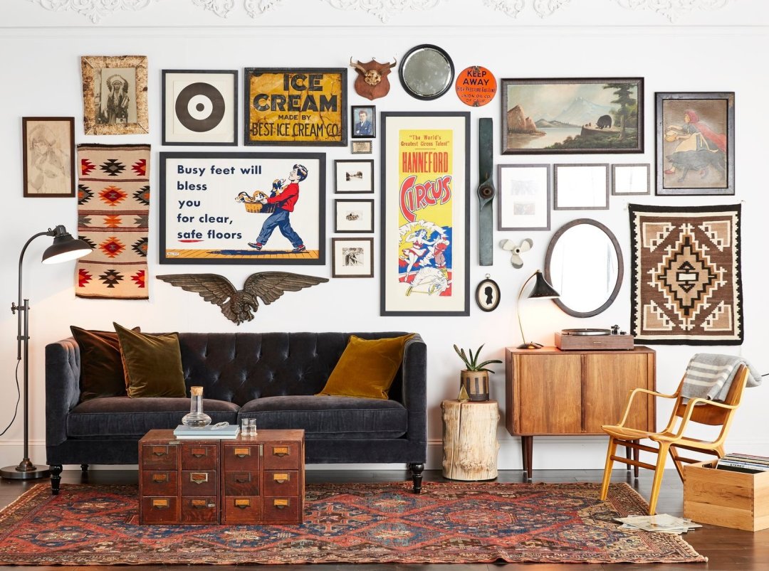 Eclectic living room with gallery wall and vintage decor.
