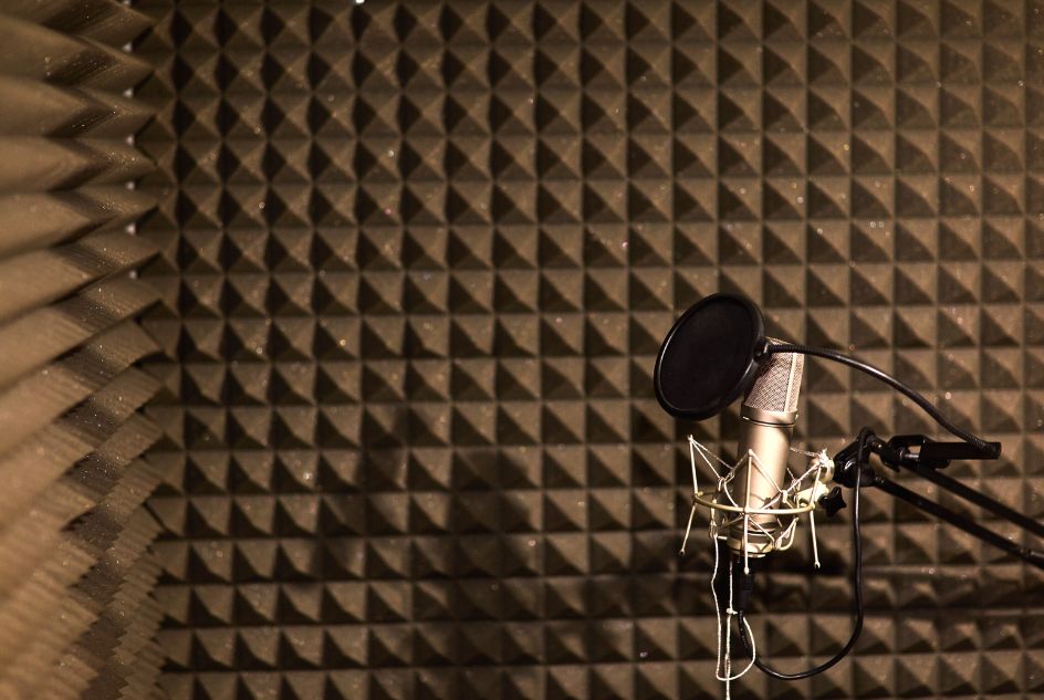 Studio microphone with acoustic foam background.