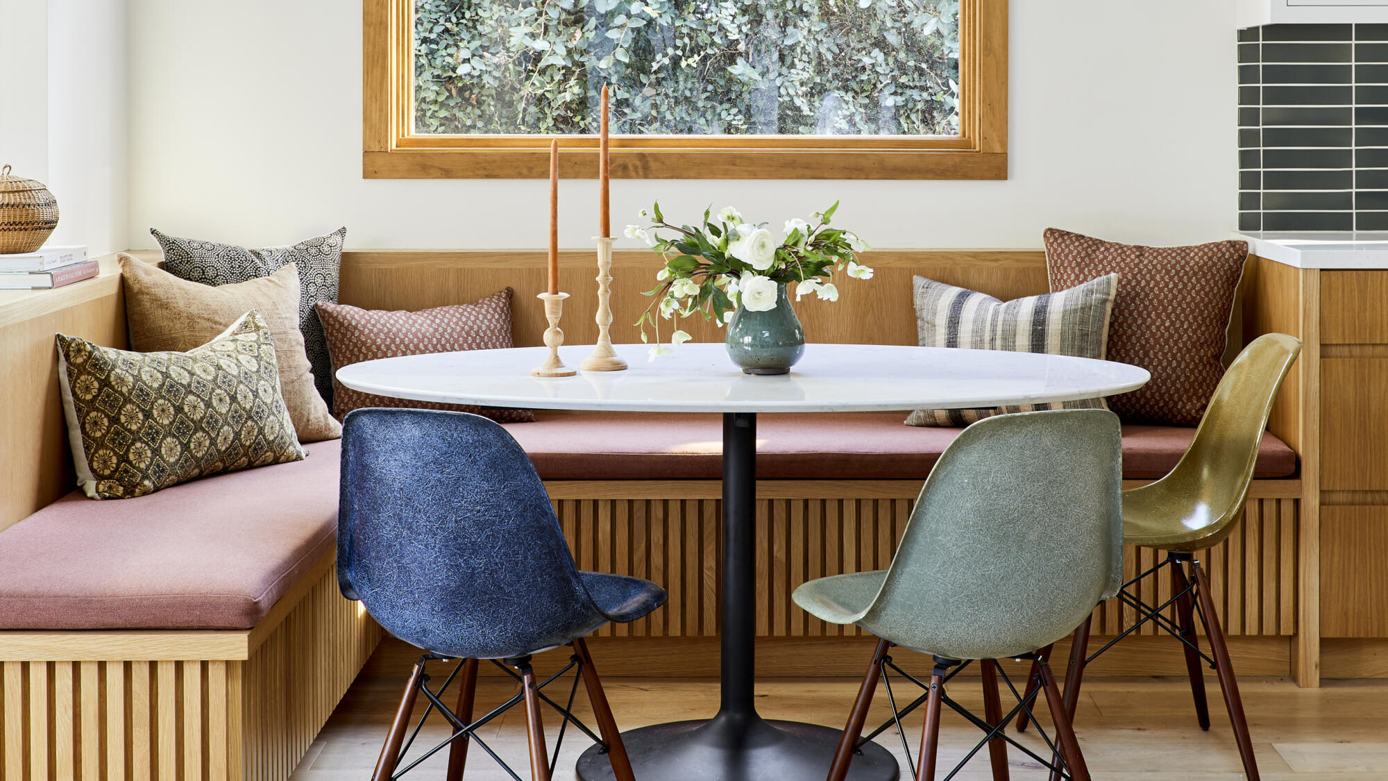 Cozy dining nook with modern chairs and wooden accents.