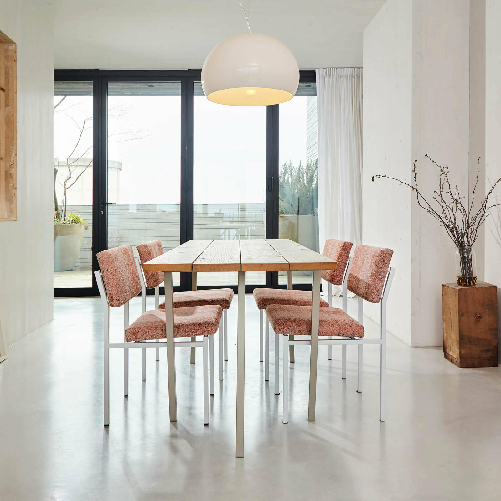 Modern dining room with table, chairs, and oversized pendant light.