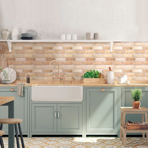 Modern kitchen with brick backsplash and green cabinets.