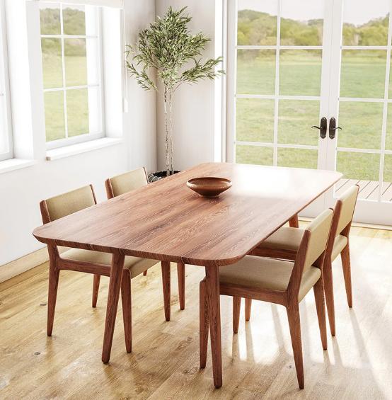 Wooden dining table with chairs near window.