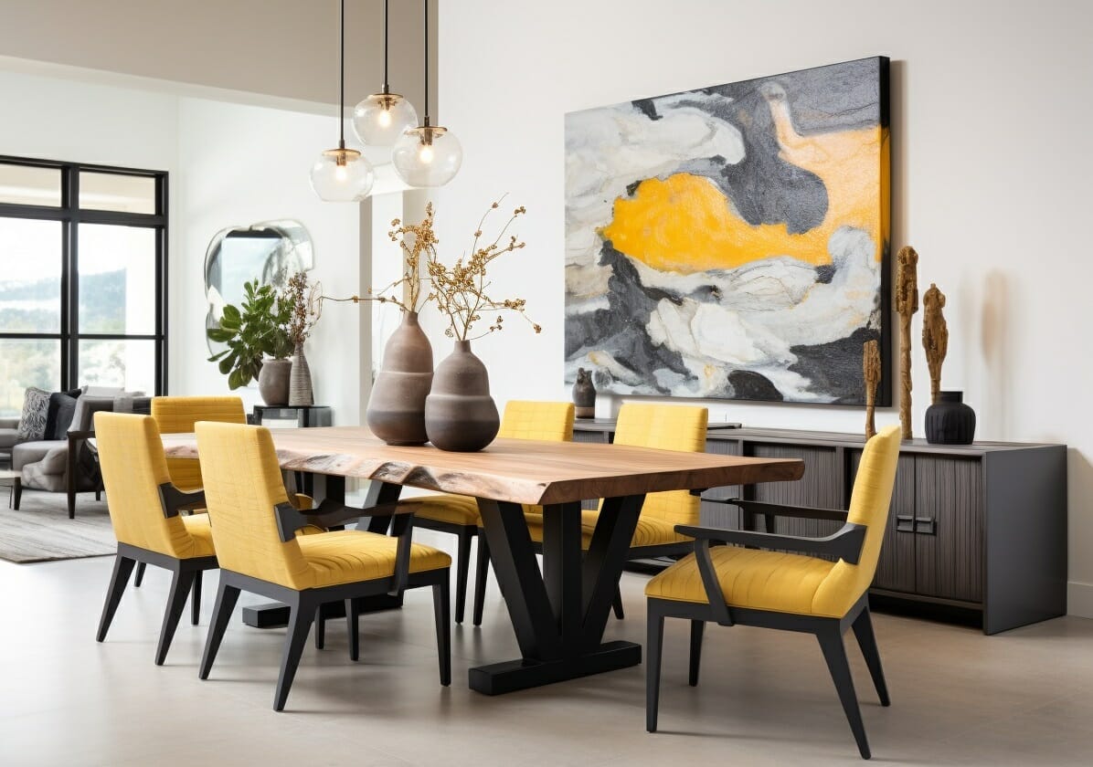 Modern dining room with yellow chairs and abstract art.