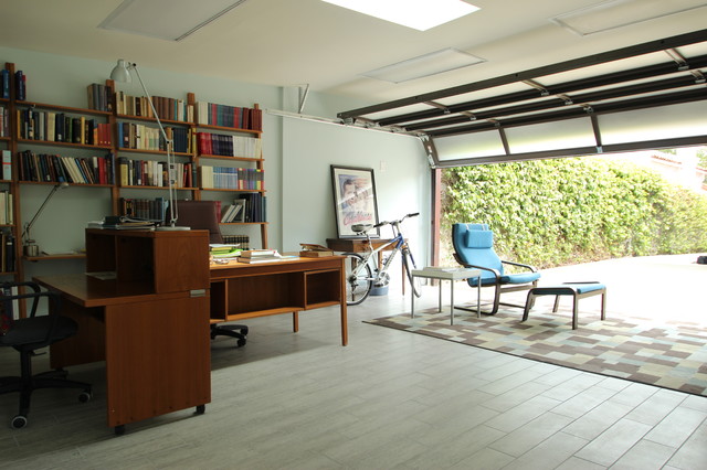 Home office with bookshelves and natural light.