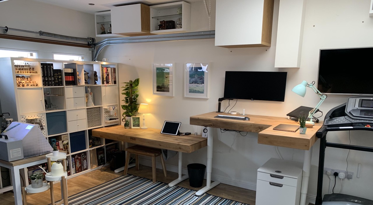 Modern home office with desk and shelving.