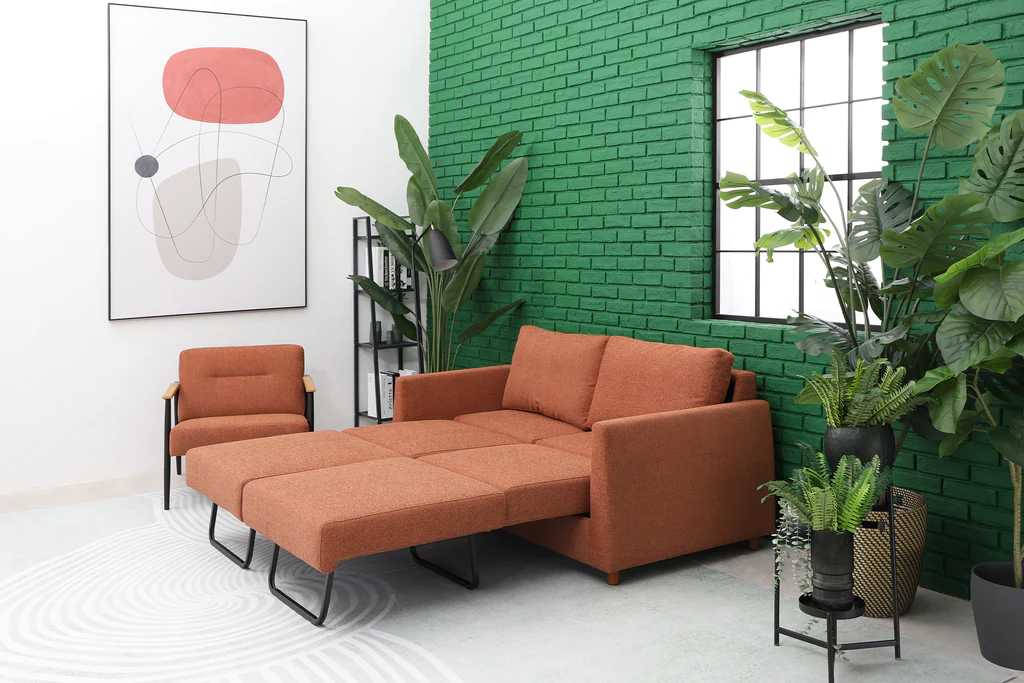 Modern living room with green brick wall and orange sofa.