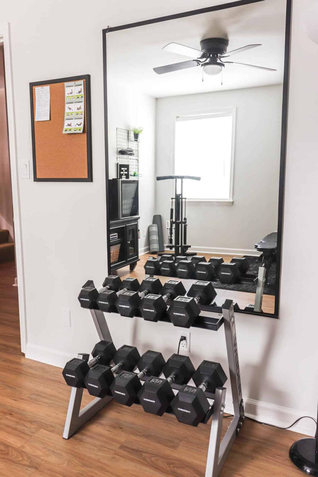 Home gym with dumbbells and exercise equipment.